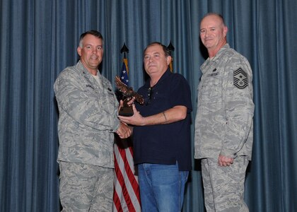 Col. Richard Murphy, 12th Flying Training Wing Commander, and Chief Master Sgt. Steven Jones, 12th FTW command chief, presents James Rouse, 902nd Logistics Readiness Squadron, with the Civilian Supervisor of the Quarter category I award during the Joint Base San Antonio Randolph 3rd Quarter Award Ceremony at the base theater at Randolph Air Force Base, Texas, Nov. 2.(U.S. Air Force photo/Melissa Peterson)