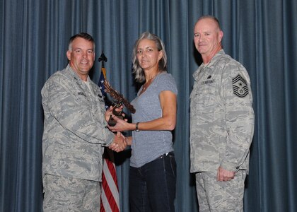 Col. Richard Murphy, 12th Flying Training Wing Commander, and Chief Master Sgt. Steven Jones, 12th FTW command chief, presents Darlene Daspit-Pohl, 560th Flying Training Squadron air crew flight equipment supervisor, with the Civilian Wage Grade of the Quarter award during the Joint Base San Antonio Randolph 3rd Quarter Award Ceremony at the base theater at Randolph Air Force Base, Texas, Nov. 2.(U.S. Air Force photo/Melissa Peterson)