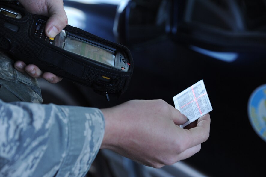 U.S. Air Force Airman 1st Class James Martin, 4th Security Forces Squadron patrolman, uses a Defense Biometric Identification System to scan identification cards at Berkeley gate on Seymour Johnson Air Force Base, N.C., Nov. 1, 2011. DBIDS is a U.S. Homeland Security and Department of Defense scanner used to manage personnel access to an installation. This program will allow 4 SFS gate guards to verify personnel entering the base by scanning the barcode located on approved Department of Defense identification cards. Martin is a native of Wooster, Ohio. (U.S. Air Force photo/Senior Airman Whitney Stanfield/Released) 
