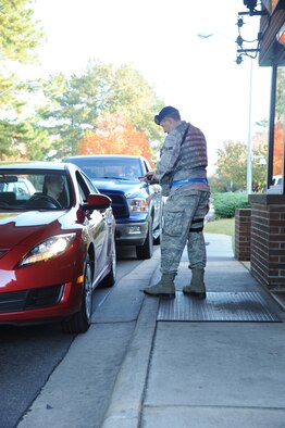 Airman 1st Class James Martin, 4th Security Forces Squadron (SFS) patrolman, scans identification cards (ID) at Berkeley gate on Seymour Johnson Air Force Base, N.C., Nov. 1, 2011. The 4 SFS began using a hand-held Defense Biometric Identification System scanner to check ID cards at all base gates starting Nov. 1. Martin is a native of Wooster, Ohio. (U.S. Air Force photo by Senior Airman Whitney Stanfield)