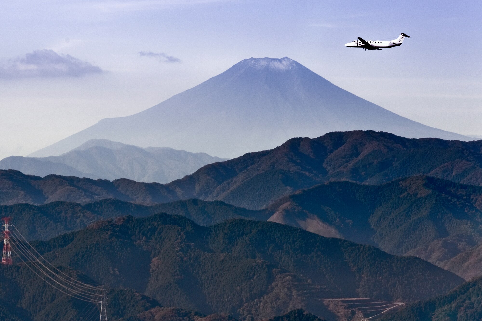 OVER JAPAN -- A C-12 Huron flies in front of Mount Fuji Nov. 2, 2011, from Yokota Air Base, Japan. The aircraft flew in an exercise known as the Samurai Surge, a day dedicated to practicing aerial formations and other aircraft maneuvers. (U.S. Air Force photo/Airman John D. Partlow)