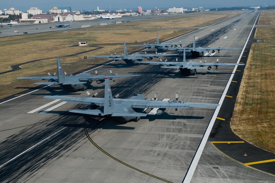 YOKOTA AIR BASE, Japan -- A formation of C-130 Hercules from the 36th Airlift Squadron stand ready for takeoff Nov. 2, 2011, at Yokota Air Base, Japan. The sortie was part of the Samurai Surge an all day exercise testing the pilots in several different areas. (U.S. Air Force photo/Osakabe Yasuo)