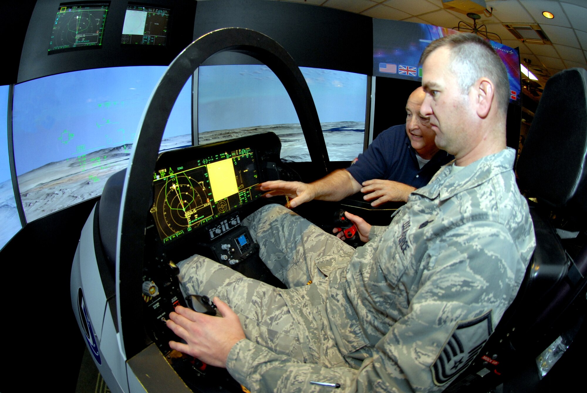 Stormy Boudreaux, an F-35 Lightning II instructor pilot with Lockheed Martin Aerodynamics, shows Master Sgt. Trevor Jackson, 8th Force Support Squadron dining facility section chief, how the new multi-role fighter will better serve the U.S. military at Kunsan Air Base, Republic of Korea, Nov. 1. The F-35 integrates advanced stealth technology into a highly agile, supersonic aircraft that provides the pilot with unprecedented situational awareness and unmatched lethality and survivability. (U.S. Air Force photo by Senior Airman Benjamin Stratton/Released)