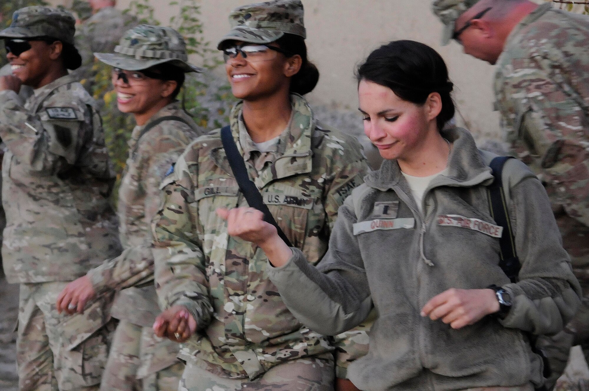 1st Lt. Cammie Quinn (right), Provincial Reconstruction Team Paktya public affairs officer, from Lubbock, Texas, dances to the tunes of Air Force Central Command band ‘Top Brass’ on Forward Operating Base, Gardez,, Oct. 28, 2011. Quinn, who organized the event, is one of more than fifty Airman and Soldiers that attended the concert. (Photo by Senior Airman Wesley Farnsworth)