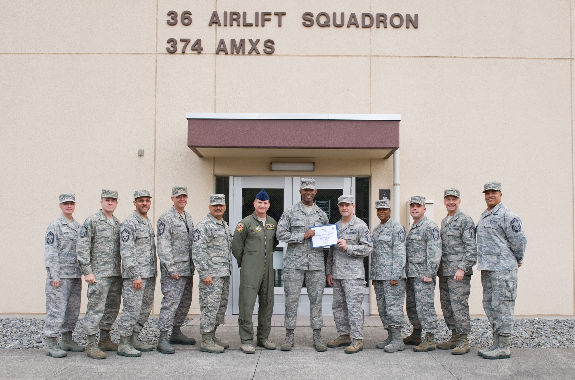 YOKOTA AIR BASE, Japan -- Staff Sgt. Bobby Jones, 36th Airlift Squadron C-130 Hercules flight engineer, poses with Yokota Chiefs' Group at Yokota Air Base, Japan, Nov. 3, 2011. The Chiefs' Group awards Airmen from the rank of Airman Basic through Tech. Sgt. for their hard work and dedication. (U.S. Air Force photo/Airman 1st Class Krystal M. Garrett)