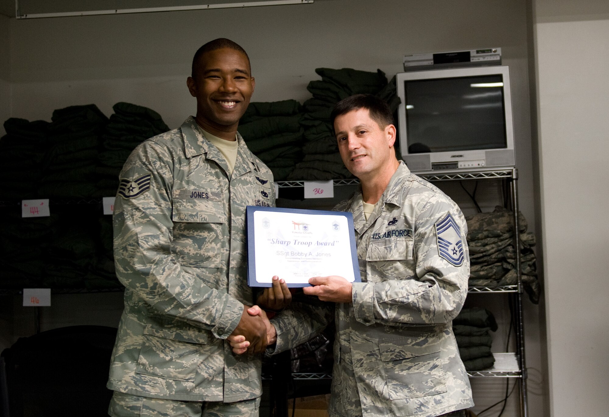 YOKOTA AIR BASE, Japan -- Staff Sgt. Bobby Jones, 36th Airlift Squadron C-130 Hercules flight engineer, receives the Sharp Troop Award at Yokota Air Base, Japan, Nov. 3, 2011. Jones has helped his squadron along with the 459th AS save money, helping the Air Force as a whole. (U.S. Air Force photo/Airman 1st Class Krystal M. Garrett) 