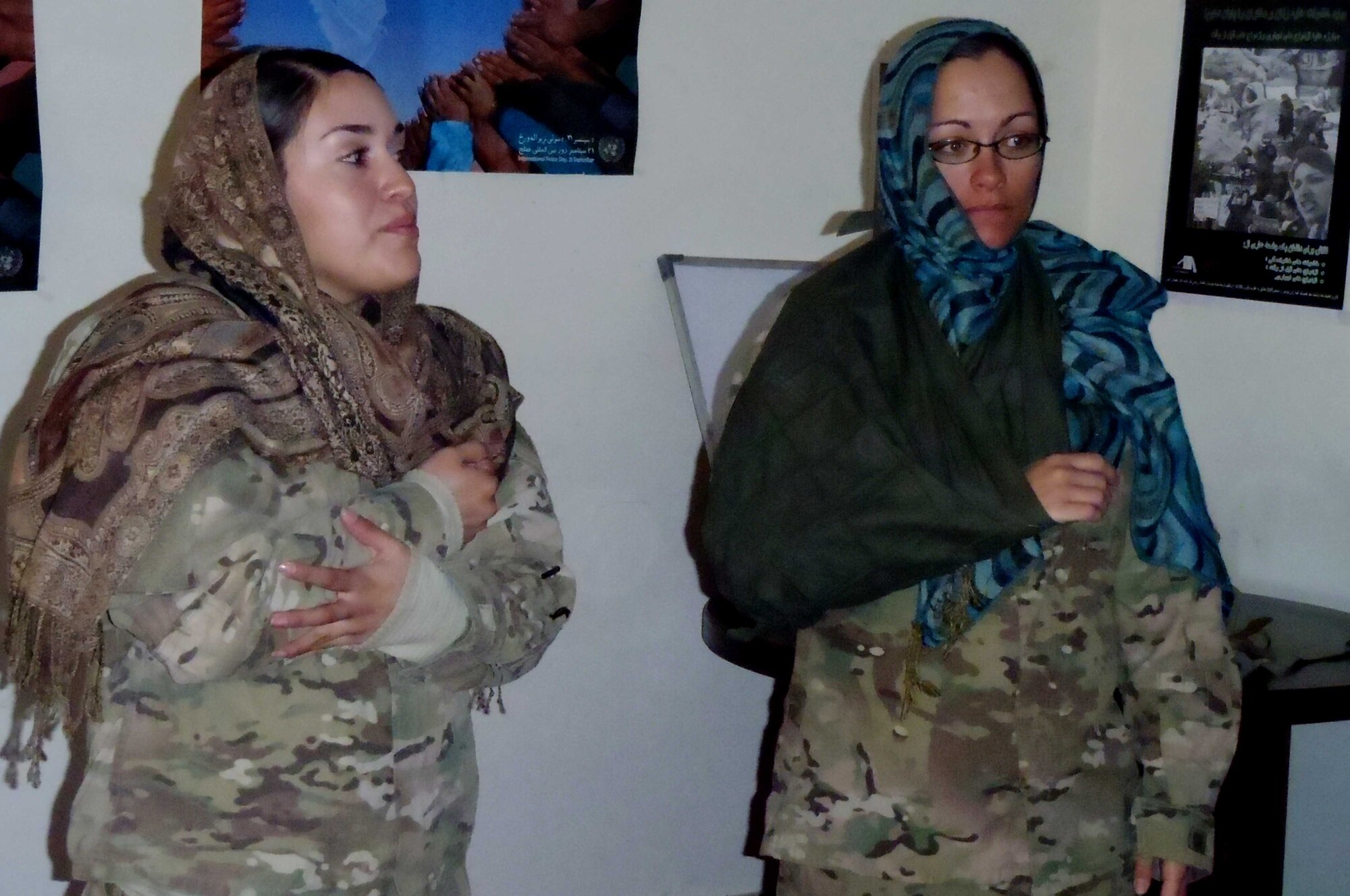 Staff Sgt. April Deluna, a Provincial Reconstruction Team Paktya medic from San Antonio, (right) and Tech. Sgt. Rebecca Rose, Nebraska Agriculture Development Team from Coleridge, Neb., demonstrate proper arm-bracing techniques at the provincial women’s development center, Nov. 1, 2011. The medics taught basic first-aid skills to 13 women from the province. (Photo by Army Maj. Katherine Williams)