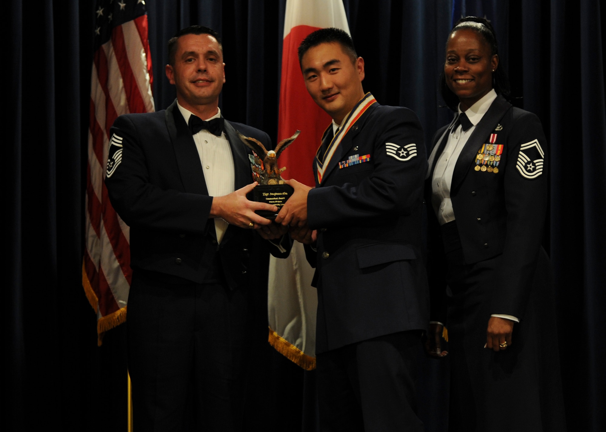 YOKOTA AIR BASE, Japan -- Staff Sgt. Jonghwan Kim, 374th Aerospace Medicine Squadron, received the Commandant Award during the Airman Leadership School graduation ceremony at Yokota Air Base, Japan, Nov. 2, 2011. (U.S. Air Force Photo/Staff Sgt. Stacy Moless)