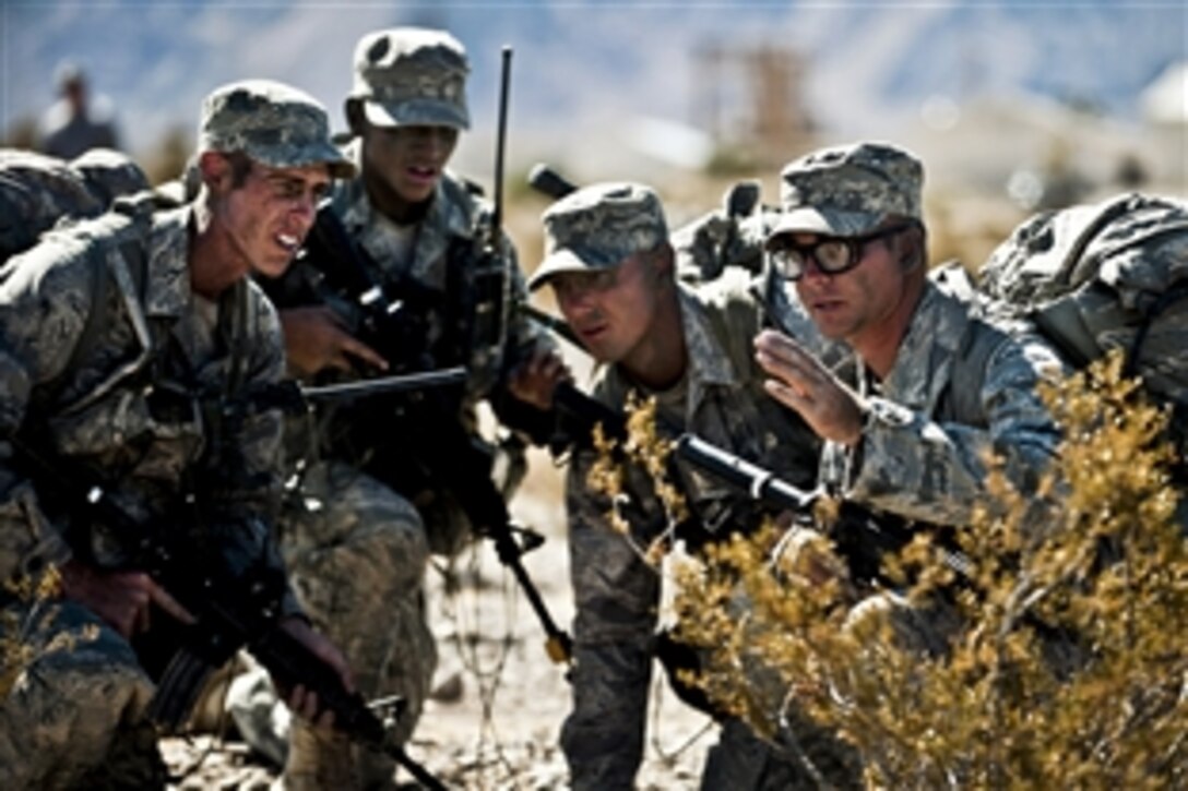 Air Force airmen training as squad leaders discuss tactics before an ambush training mission during a ranger assessment and selection course at the Nevada Test and Training Range on Nellis Air Force Base, Nev., Oct. 21, 2011. Airmen must attend the course before advancing to Army Ranger School. 