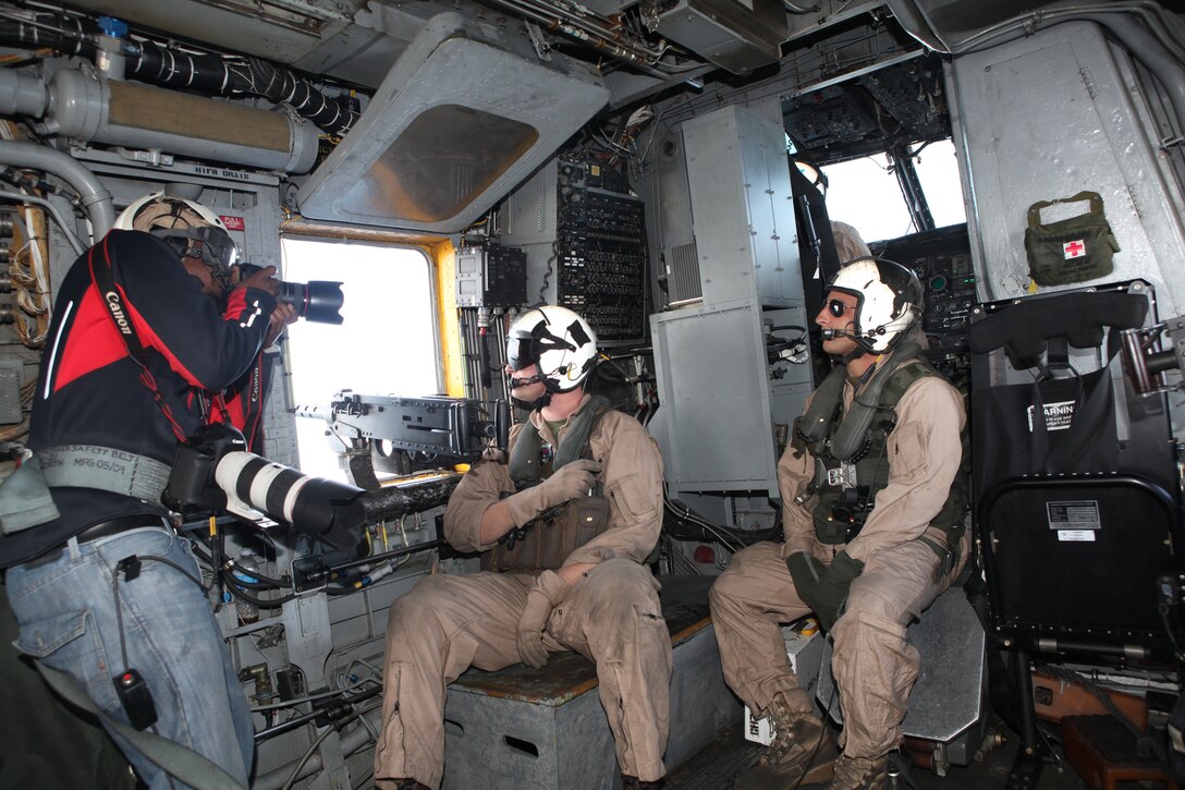 Collin Chappelle, left, a photographer with Jason Maris Photography and hired by Marine Corps Recruiting Command, photographs Cpl. Benjamin H. Cockrel, center, a maintenance crew member with Marine Heavy Helicopter Squadron 361 and an Ottawa, Ill., native, and Cpl. Justin R. Walker, right, a crew chief with HMH-361 and a York, Pa., native, during the filming of a Marine Corps recruitment commercial aboard Marine Corps Air Station Miramar, Calif., Nov. 3. The squadron sent two CH-53E Super Stallions to fly over a Marine Air-Ground Task Force assault zone for the filming of the 2012 Marine Corps Recruiting Command commercial entitled “Sounds of Chaos.”