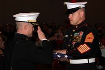 Recruiting Station Twin Cities Commanding Officer Maj. Kenneth Gawronski salutes Master Sgt. William R. Henderson during his retirement ceremony after the 236th Marine Corps Birthday celebration Nov. 4. Gunnery Sgt. Joseph R. Sutter also retired that evening after serving more than 20 years on active duty. For additional imagery, visit www.facebook.com/rstwincities.