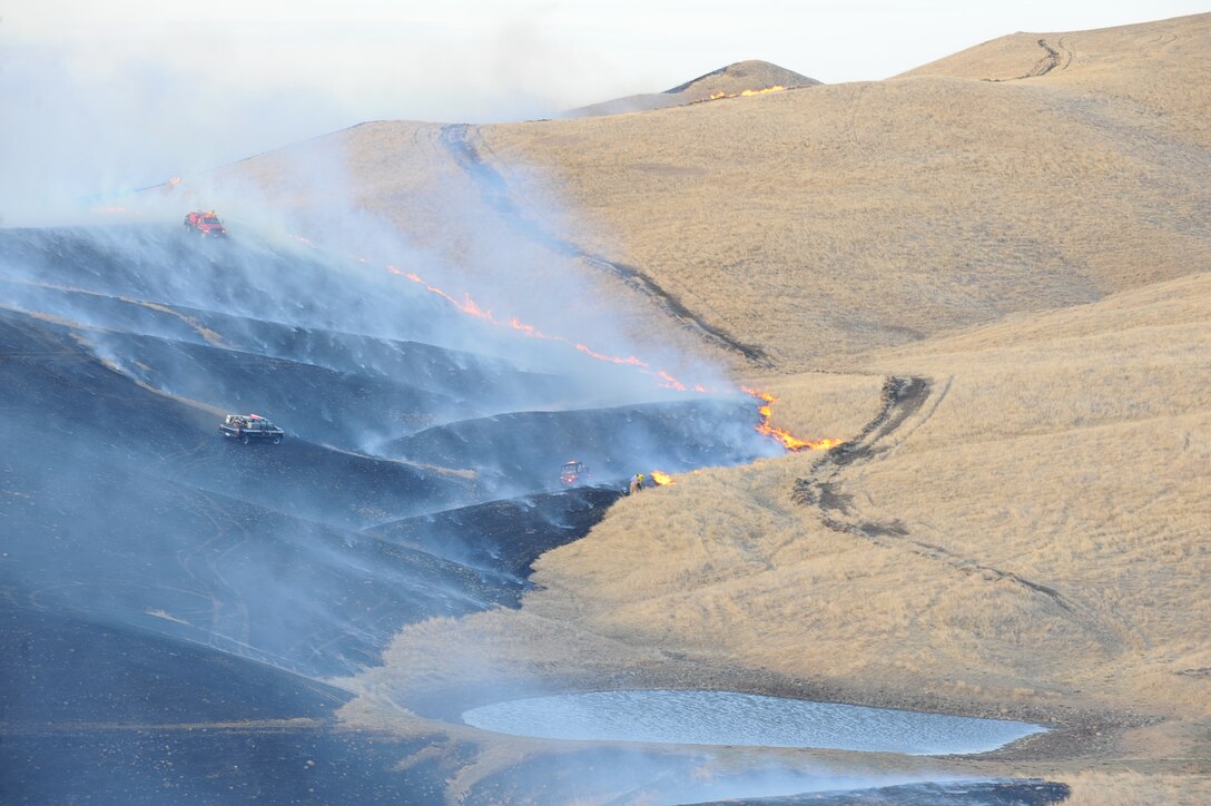Firefighters work to contain a grassland fire ignited north of Ellsworth Air Force Base, Nov. 3, 2011. The fire started on Ellsworth and quickly spread to private land. (U.S. Air Force photo by Airman 1st Class Zachary Hada/Released)