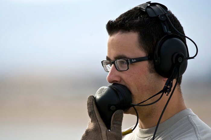 U.S. Air Force Staff Sgt. Rory Havens, 7th Aircraft Squadron crew chief, Dyess Air Force Base, Texas, communicates with a B-1 Lancer air crew prior to launch during the integrated tactics phase of the U.S. Air Force Weapons School Nov. 3, 2011, at Nellis Air Force Base, Nev. The 77th Weapons Squadron, part of the part of the U.S.A.F.W.S., provides instructional flying and tactics training for students piloting the B-1 Lancer. (U.S. Air Force photo by Senior Airman Brett Clashman/Released)