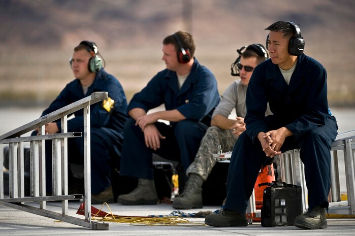 U.S. Air Force Staff Sgt. Jonel Guihama, B-1B electrical/environmental systems craftsman, 7th Aircraft Maintenance Squadron, Dyess Air Force Base, Texas, and fellow Airmen take a break during the integrated tactics phase of the U.S. Air Force Weapons School Nov. 3, 2011, at Nellis Air Force Base, Nev. The 77th Weapons Squadron, part of the U.S.A.F.W.S., provide instructional flying and tactics training for students piloting the B-1 Lancer. (U.S. Air Force photo by Senior Airman Brett Clashman/Released)

