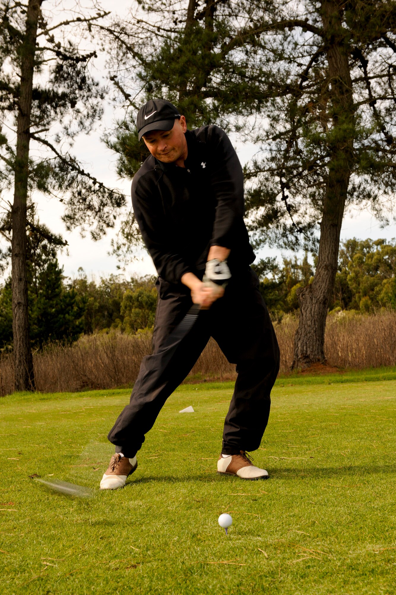 VANDENBERG AIR FORCE BASE, Calif. -- Lt. Col. Trevor Laine, from the14th Air Force, drives a ball to the green during a golf tournament hosted by members of Vandenberg's Commonwealth here Friday, Nov. 4, 2011. The event was a small gesture of appreciation for Vandenberg members for helping the Commonwealth personnel and their families feel welcome while thousands of miles away from their homeland. (U.S. Air Force/Staff Sgt. Levi Riendeau)