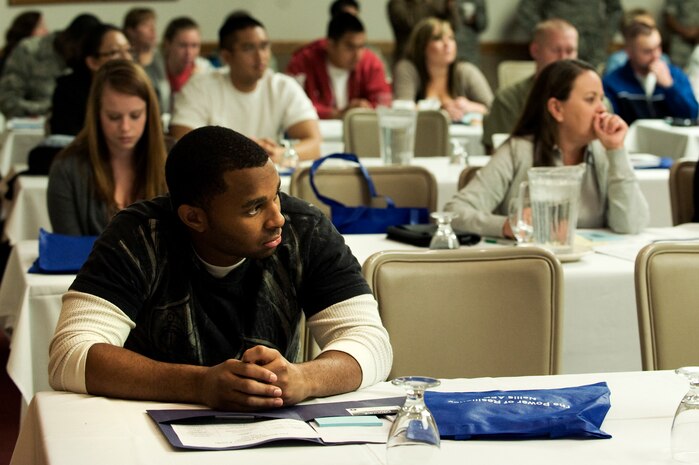 Military members and dependents listen to briefings during the Resilient Military Family Symposium Nov. 4, 2011, at Nellis Air Force Base, Nev. The symposium is designed to give family members the tools, knowledge, and resources to empower themselves to adapt to the rigors of the military environment. (U.S. Air Force photo by Staff Sgt. Christopher Hubenthal/Released)
