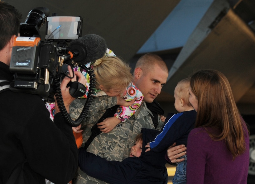 Staff Sgt. Justin Hebert, 22nd Maintenance Operations Squadron returning Airman, greets his family Nov. 3, 2011, McConnell Air Force Base, Kan. Hebert along with several other Airmen returned home after the completion of their operations in Libya. McConnell deployed more than 200 Airmen to Europe during the U.S. part of the military operation called ODYSSEY DAWN and the NATO-led operation UNIFIED PROTECTOR. (U.S. Air Force photo/Airman 1st Class Maurice Hodges) 