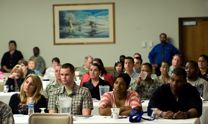 Military members and dependents listen to briefings during the Resilient Military Family Symposium Nov. 4, 2011, at Nellis Air Force Base, Nev. The symposium is designed to give family members the tools, knowledge, and resources to empower themselves to adapt to the rigors of the military environment. (U.S. Air Force photo by Staff Sgt. Christopher Hubenthal/Released)