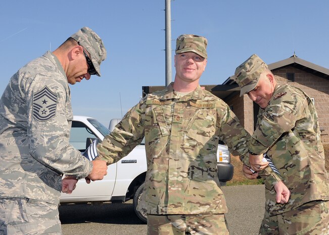 Chief Master Sgt. Robert White, 9th Reconnaissance Wing command chief, and Chief Master Sgt. Anthony Koberstein, 9th Munitions Squadron (9th MUNS), recognize Senior Master Sgt. Tony Crotts for being selected to promotion to chief master sergeant at Beale Air Force Base, Calif., Nov. 2, 2011. Crotts is the curriculum flight chief for the 9th MUNS. (U.S. Air Force photo by Mr. Sean Bhakta)