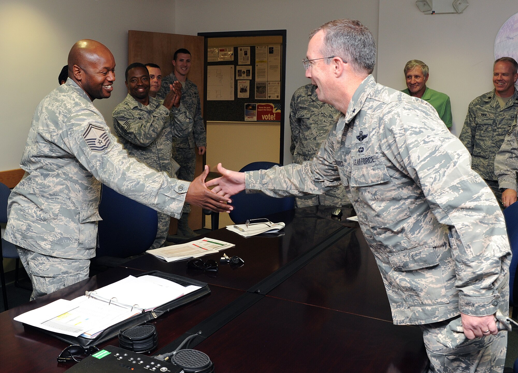 Brig. Gen Paul McGillicuddy, 9th Reconnaissance Wing commander, recognizes Senior Master Sgt. Edward Ames for being selected to promotion to chief master sergeant at Beale Air Force Base, Calif., Nov. 2, 2011. Less than one percent of the Airmen are ever promoted to the rank of E-9. (U.S. Air Force photo by Mr. Sean Bhakta)