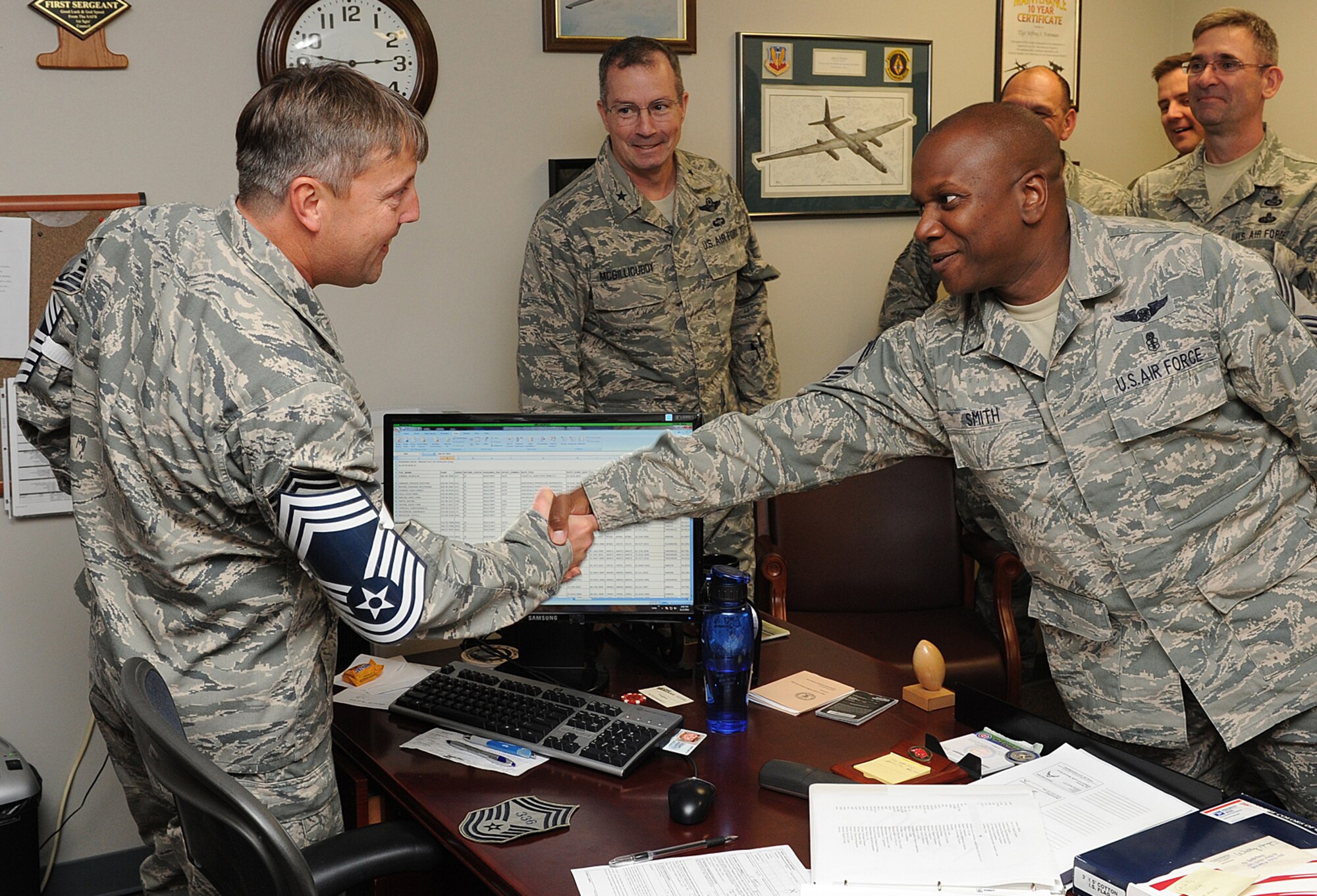 Senior Master Sgt. Jeffrey Foreman is recognized by Chief Master Sgt. Wayne Smith as Brig. Gen Paul McGillicuddy, 9th Reconnaissance Wing commander, and other Beale chiefs look on at Beale Air Force Base, Calif., Nov. 2, 2011. The commander, command chief and members of Beale's top enlisted force went to each individual selected for chief to congratulate them. (U.S. Air Force photo by Mr. Sean Bhakta)
