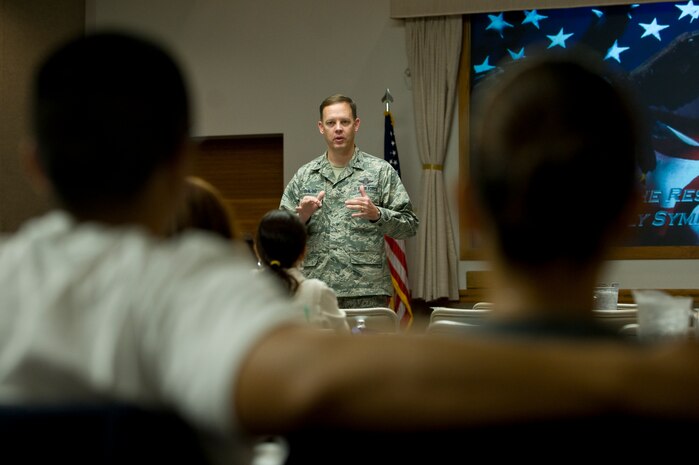 U.S. Air Force Col. Steve Garland, 99th Air Base Wing commander, briefs at the Resilient Military Family Symposium Nov. 4, 2011, at Nellis Air Force Base, Nev. The symposium is designed to give family members the tools, knowledge, and resources to empower themselves to adapt to the rigors of the military environment. (U.S. Air Force photo by Staff Sgt. Christopher Hubenthal/Released)