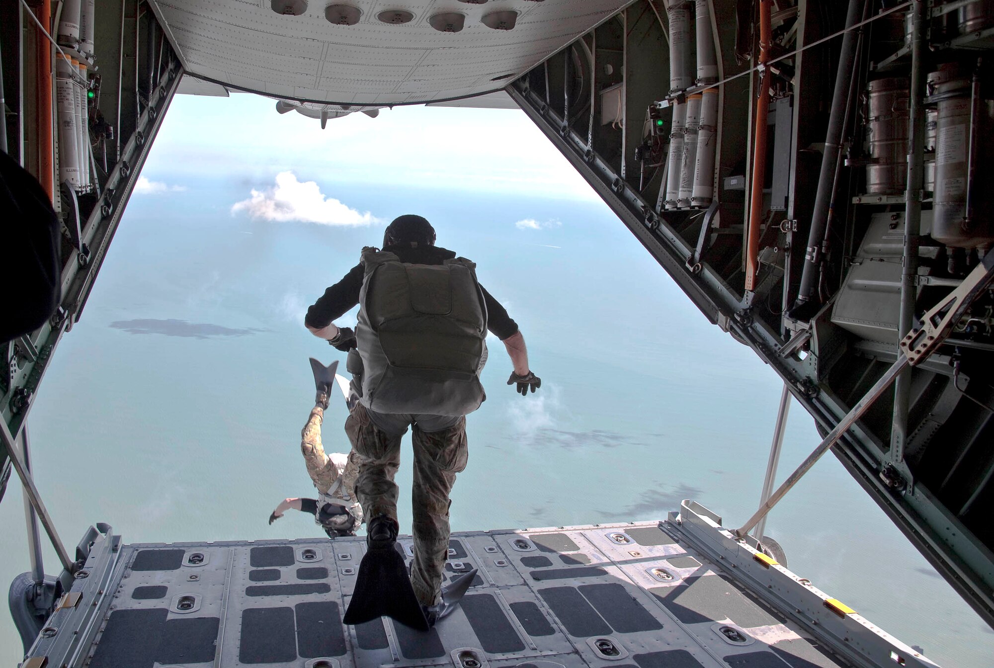 PATRICK AIR FORCE BASE, Fla.- Pararescuemen from the 920th Rescue Wing here, free fall out of an HC-130P/N King refueling aircraft at 3,500 ft. during a demo for the Cocoa Beach Air Show. PJ's deploy around the world via the air, land and sea into a wide range of environments to extract, treat, stabilize and evacuate injured personnel. Their motto, "That Others May Live," reaffirms the PJ's commitment to saving lives and self-sacrifice. (Courtesy photo/Mr. Mike Brown)