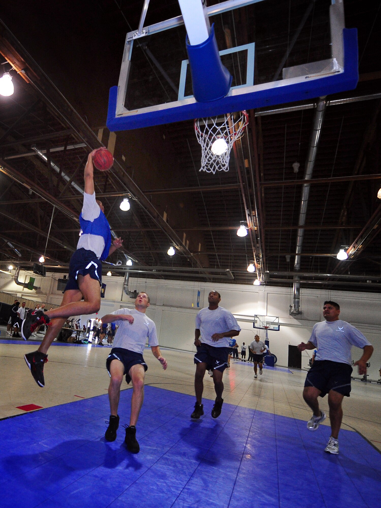 U.S. Air Force Senior Airman Justin Thomas, with the 338th Combat Training Squadron, flies through the air while participating in the annual Wingman Day activities held in the field house at Offutt Air Force Base, Neb., Nov. 4.   The day's activities included a cardboard boat race, tug-o-war, basketball, bowling, and a dodgeball tournament. (U.S. Air Force photo by Josh Plueger/Released)
