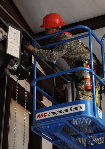 Master Sgt. Andrew Campos, 819th Red Horse Squadron, Malstrom Air Force Base, Mont., installs electricity to a door on a new pre-engineered building Nov. 3, 2011, at Dyess AFB, Texas. Red Horse is constructing a 8,500-square-foot facility for 7th Civil Engineer Squadron craftsmen to perform maintenance duties and will also consolidate three other facilities being used by 7 CES. (U.S. Air Force photo by Airman 1st Class Peter Thompson/ Released)