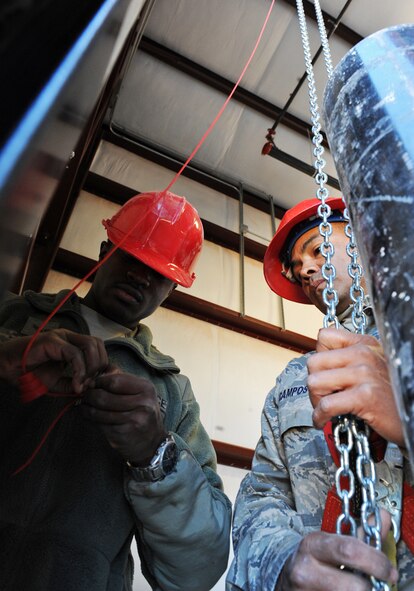 Airman 1st Class Tony Rice and Master Sgt. Andrew Campos, 819th Red Horse Squadron, Malstrom Air Force Base, Mont., install electricity to a door on a new pre-engineered building Nov. 3, 2011, at Dyess AFB, Texas. Red Horse is constructing a 8,500-square-foot facility for 7th Civil Engineer Squadron craftsmen to perform maintenance duties and will also consolidate three other facilities being used by 7 CES. (U.S. Air Force photo by Airman 1st Class Peter Thompson/ Released)