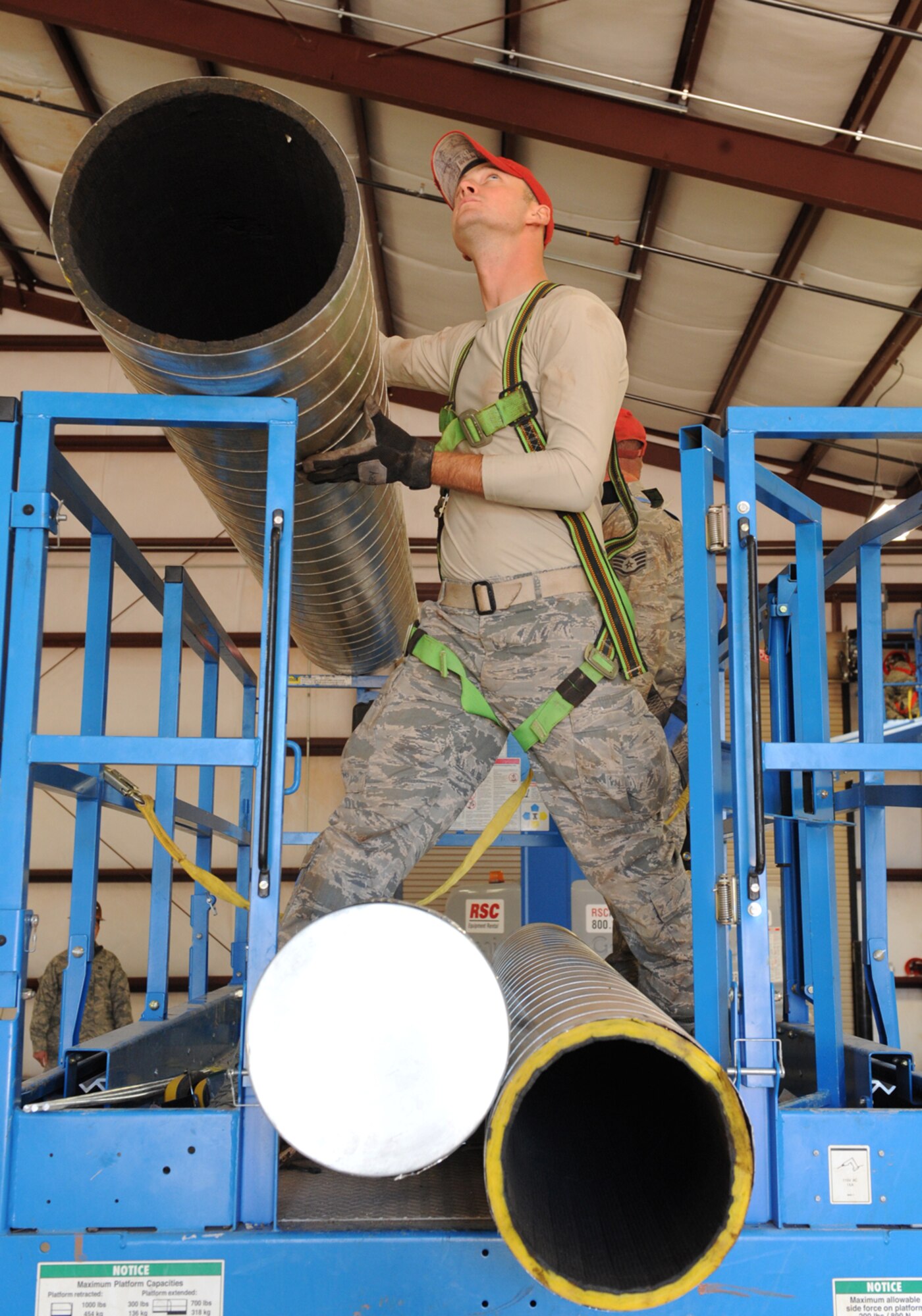 Airman 1st Class Zachary Terry, 819th Red Horse Squadron, Malstrom Air Force Base, Mont., installs air ducts in a pre-engineered building Nov. 3, 2011, at Dyess AFB, Texas. Red Horse is constructing a 8,500-square-foot facility for 7th Civil Engineer Squadron craftsmen to perform maintenance duties and will also consolidate three other facilities being used by 7 CES. (U.S. Air Force photo by Airman 1st Class Peter Thompson/ Released)