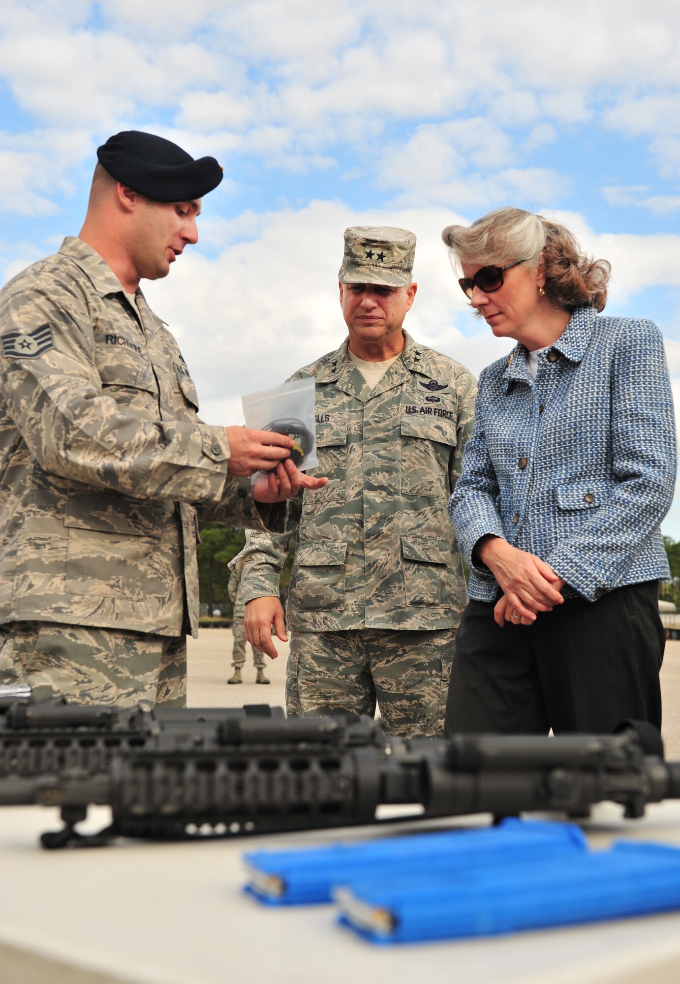 U.S. Air Force Staff Sgt. Ross Richwine, 20th Security Forces Squadron combat arms instructor, shows Maj. Gen. Lawrence Wells, 9th Air Force commander, and his wife Mrs. Kathy Wells, a replacement cord for a taser gun Nov. 3, 2011, Shaw Air Force Base, S.C. General and Mrs. Wells took an official tour of the 20th Fighter Wing to gain insight into the mission and speak with Airmen from units across the base to hear their concerns.  (U.S. Air Force photo by Airman 1st Class Amber E. N. Jacobs/Released) 