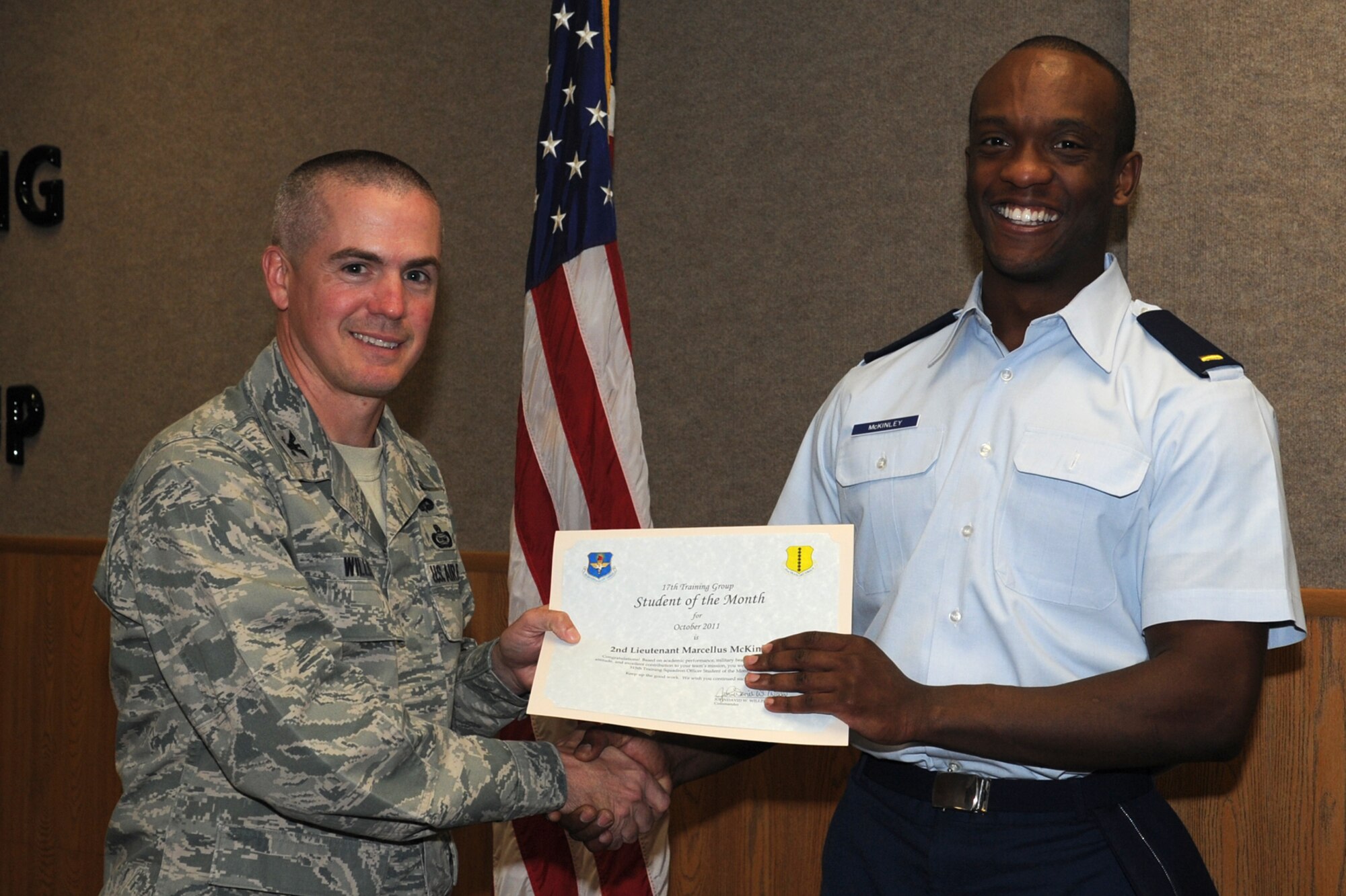 GOODFELLOW AIR FORCE BASE, Texas -- Col. JD Willis, 17th Training Group Commander, presents 2nd Lt. Marcellus McKinley with the 315th Training Squadron Officer Student of the Month award for October, Nov. 4. (U.S. Air Force photo/Staff Sgt. Laura R. McFarlane)