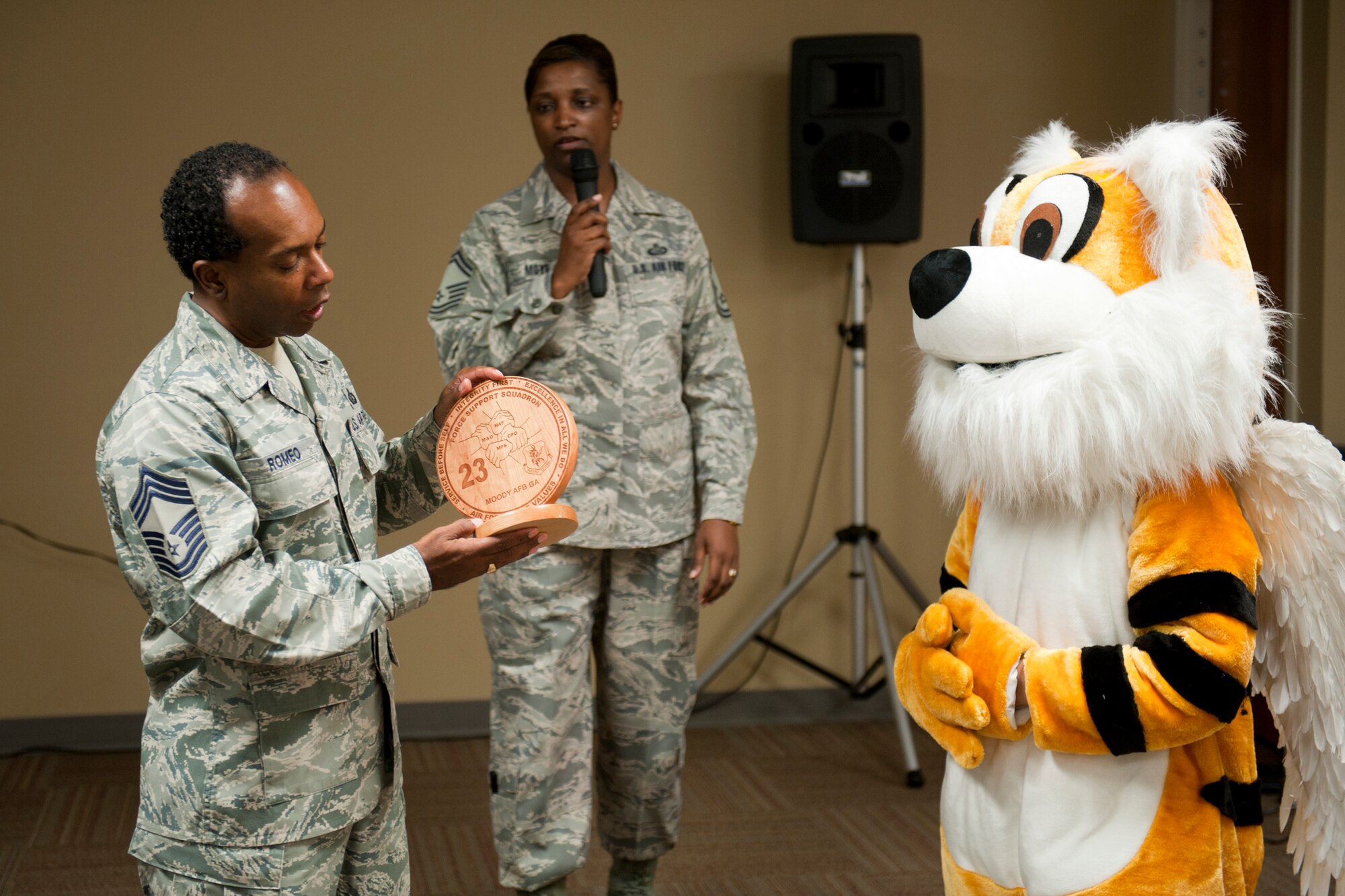 U.S. Air Force Chief Master Sgt. Joe Romeo, Air Combat Command services functional manager, receives a gift from the Flying Tiger mascot at Moody Air Force Base, Ga., Nov. 2, 2011. Representatives from the 23rd Force Support Squadron thanked Romeo for the motivation and insight he shared with the squadron during his visit. (U.S. Air Force photo by Staff Sgt. Jamal D. Sutter/Released)
