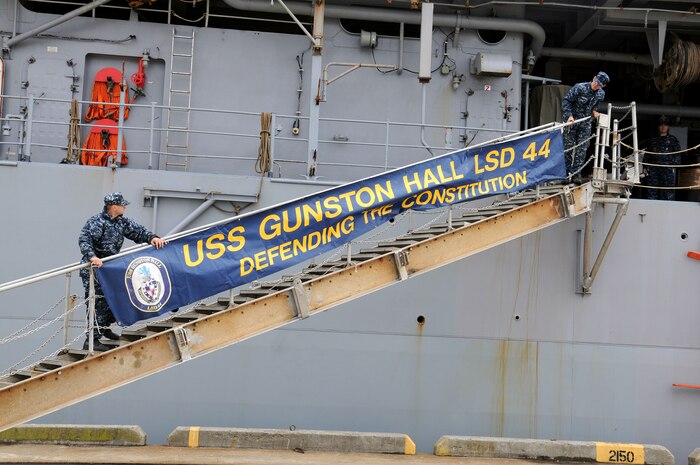 Seaman James Wahl and Seaman Nicholas Loewen secure the ship’s brow-skirt after securing USS Gunston Hall’s (LSD 44) accommodation ladder at Union Pier, downtown Charleston, Nov. 4. The Gunston Hall supports amphibious operations via helicopters, Landing Craft Air Cushion and conventional landing craft. Wahl and Loewen are attached to USS Gunston Hall (LSD 44) and work in 2nd Division Deck Department. (U.S. Navy photo/Petty Officer 1st Class Jennifer Hudson)