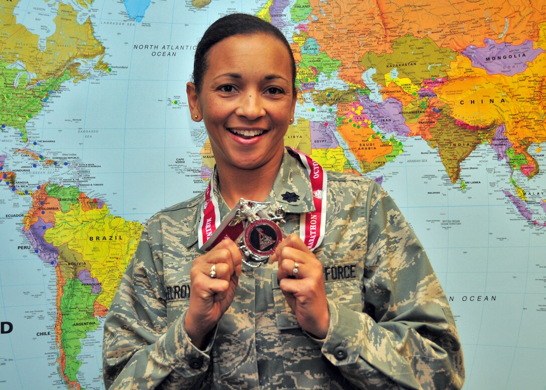 Lt. Col. Maria McElroy poses with her Marine Corps Marathon medal November 4, 2011 Niagara Falls Air Reserve Station, NY. Lt. Col McElroy was awarded the medal for her completion of the Marine Corps Marathon held in Washington, DC. (U.S. Air Force photo by Staff Sgt. Joseph McKee)