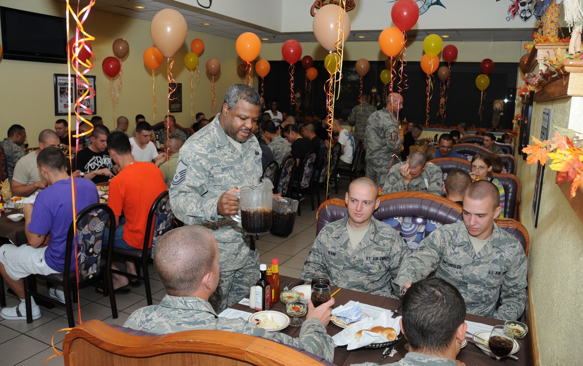 Master Sgt. Louis Bridges, 336th Training Squadron, refills drinks for students who attended the birthday dinner  Nov. 2, 2011, at Magnolia Dining Facility, Keesler Air force Base, Miss. The monthly birthday celebrations are for both permanent party and technical training students and they are served a free meal by dining hall employees and senior enlisted members.  (U.S. Air Force photo by Kemberly Groue)