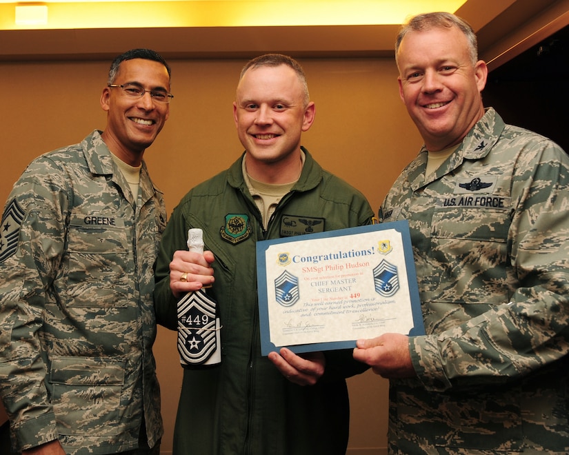 Senior Master Sgt. Philip Hudson stops for a photo with Command Chief Master Sgt. Terrence Greene and Col. Erik Hansen after being notified he was a selectee for Chief. Chiefs make up less than one percent of the Air Force enlisted members. Hudson is the C-17 special operations division superintendent with the 437th Operations Group, Green is the command chief and Hansen is the commander; both are with the 437th Airlift Wing. (U.S. Air Force photo/Staff Sgt. Katie Gieratz)(Released)