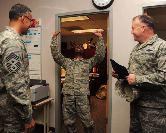 Senior Master Sgt. Terry Jones reacts to finding out he is one of five individuals from Joint Base Charleston to make Chief Master Sgt., Nov. 2, 2011. The selectees were notified by base leadership and a group of Chiefs from around the base. Jones is the host aviation resource management superintendent and is with the 437th Operations Support Squadron. (U.S. Air Force photo/Staff Sgt. Katie Gieratz)(Released)