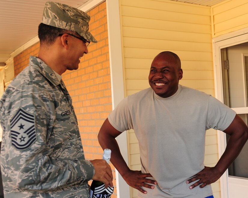 Senior Master Sgt. Kendric Shropshire reacts to being notified that he made Chief Master Sgt. while speaking with Chief Terrence Greene, on Nov. 2, 2011. Shropshire is the 437th Maintenance Squadron flight chief and Greene is the 437th Airlift Wing command chief. (U.S. Air Force photo/Staff Sgt. Katie Gieratz)(Released)
