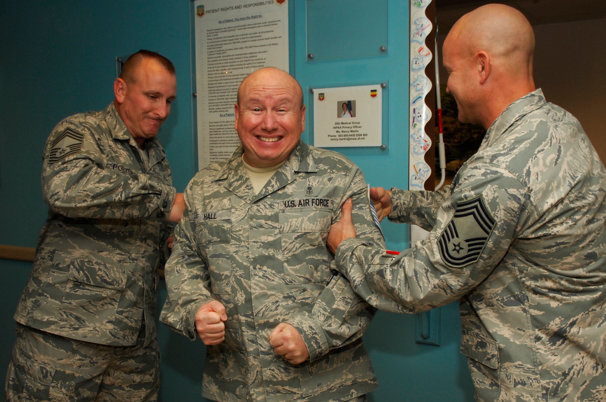 U.S. Air Force Senior Master Sgt. Eric Hall, 20th Dental Squadron superintendent, gets “tacked on” by Chief Master Sgt. Patrick Porter, 20th Mission Support Group chief and Chief Master Sgt. Charles Campbell, Air Force Central Command A6, Shaw Air Force Base, S.C. Nov.3, 2011. Several of Shaw’s chiefs visited different squadrons congratulating and welcoming the chief selects to the chief family. (U.S. Air Force photo by Airman 1st Class Ashley L. Gardner/ Released)