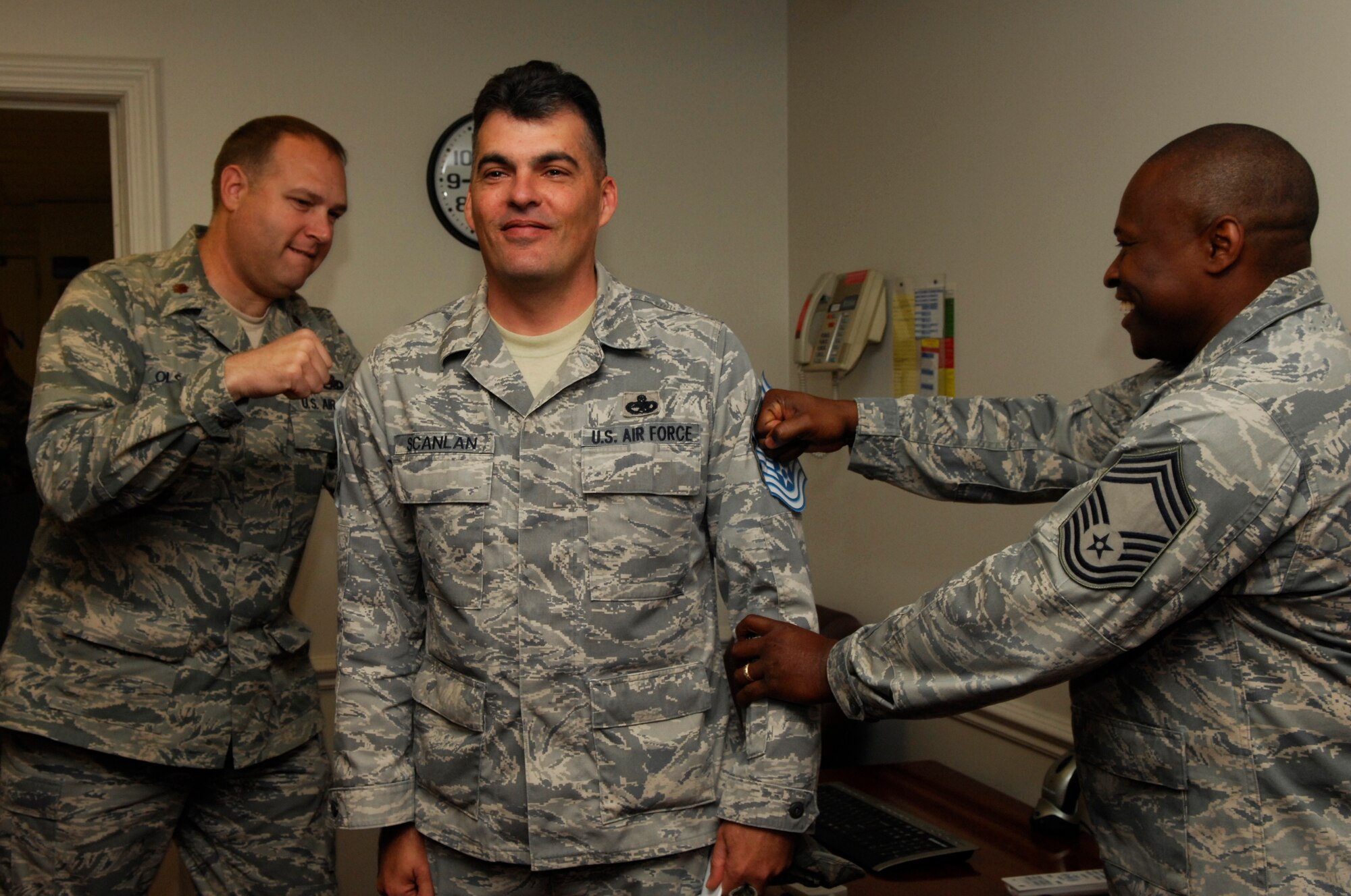 U.S. Air Force Senior Master Sgt. Mark Scanlan, 20th Component Maintenance Squadron superintendent, gets “tacked on” by Maj. Phillip Olson and Chief Master Sgt. Christopher Gooding, 20th Component Maintenance Squadron, Shaw Air Force Base, S.C. Nov.3, 2011. Several of Shaw’s chiefs visited different squadrons congratulating and welcoming the chief selects to the chief family. (U.S. Air Force photo by Airman 1st Class Ashley L. Gardner/ Released)