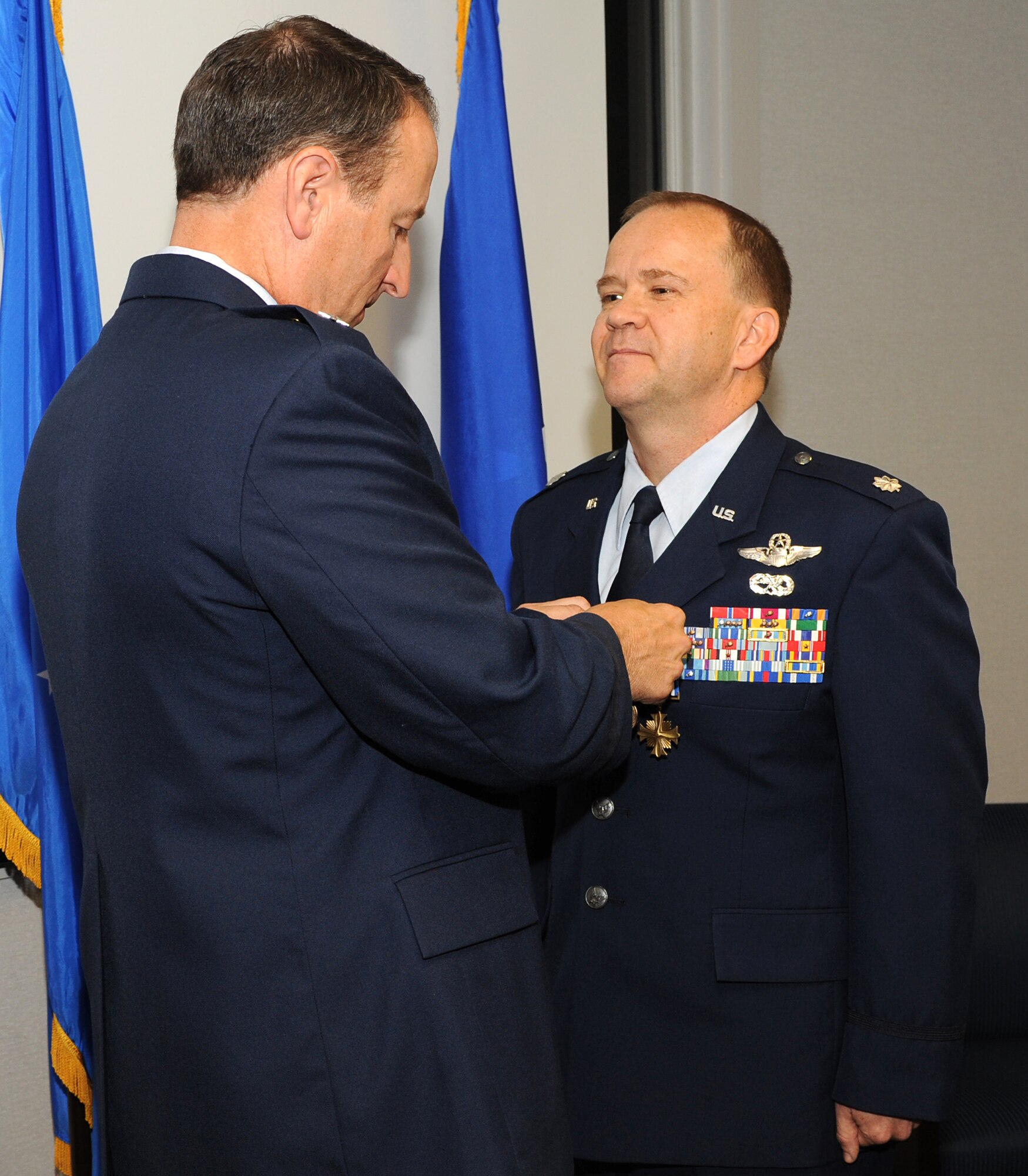 U.S. Air Force Maj. Gen. Michael Boera, Air Combat Command director of requirements, presents the Distinguished Flying Cross to Lt. Col. Bernard Willi, ACC Personnel Recovery Core Function Team chief, at Langley Air Force Base, Va., Oct. 31, 2011. Willi performed hazardous rescues under constant enemy threat during severe flooding in Nangahar and Kunar provinces, Afghanistan, July 28-29, 2010. (U.S. Air Force photo by Airman 1st Class Teresa Cleveland/Released)