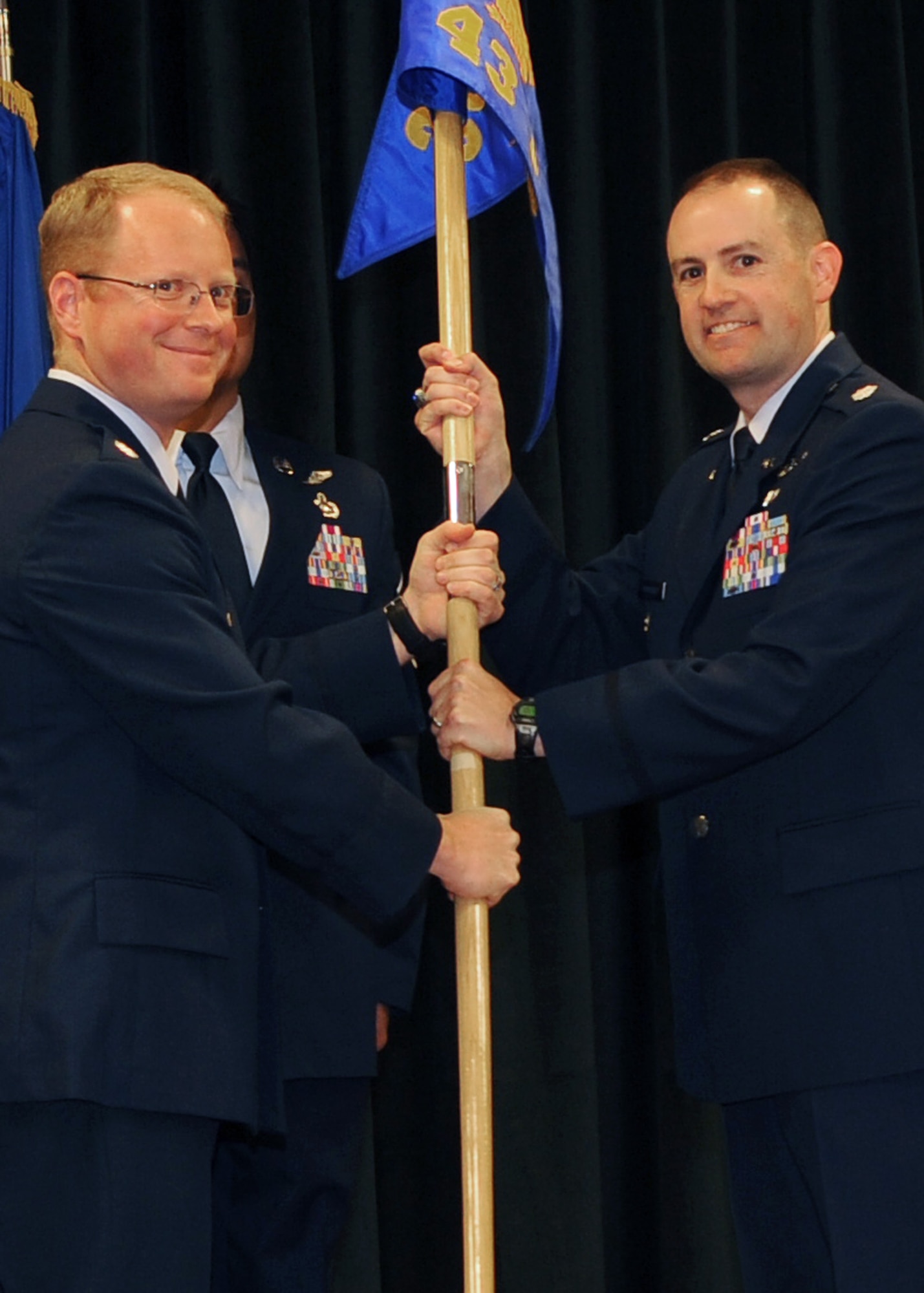 Lt. Col. Matthew Atkins, 25th Intelligence Squadron commander, passes the guidon to Lt. Col. Frederick Humphrey, 43rd Intelligence Squadron commander, during a squadron activation ceremony for the 43 IS at Cannon Air Force Base, N.M., Nov. 1, 2011.  The 43 IS is a tenant squadron here, taking the place of Detachment 1, 25th Intelligence Squadron which was inactivated. (U.S. Air Force photo by Airman 1st Class Xavier Lockley)
