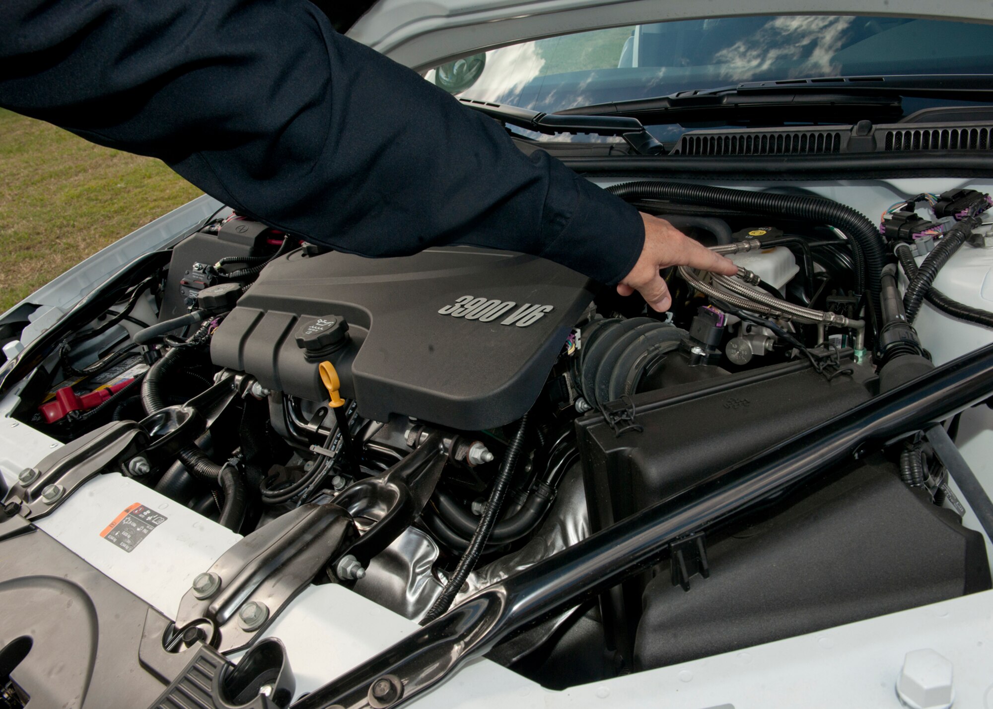Retired U.S. Air Force Tech. Sgt. David Taylor, Department of the Air Force, points to the advanced brake lines in the new patrol cars that were put to use two weeks ago Nov. 2, 2011, at Moody Air Force Base, Ga. The squadron received additional equipment for the new patrol cars, including windshield-mounted cameras and mini-light bars on the mirrors and headlights. (U.S. Air Force photo by Senior Airman Eileen Meier/Released)