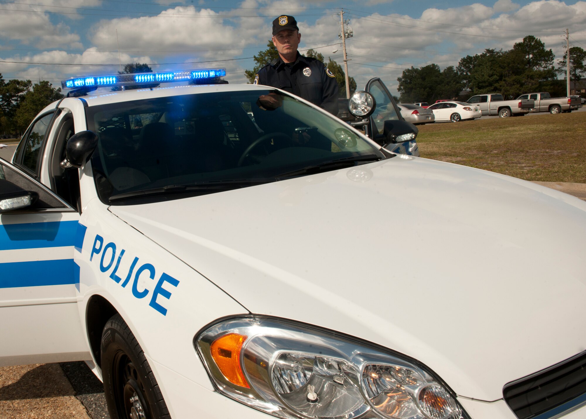 Retired U.S. Air Force Tech. Sgt. David Taylor, Department of the Air Force, stands next to one of the brand new patrol cars he operates at Moody Air Force Base, Ga., Nov. 2, 2011. Along with the vehicles, the squadron got other equipment such as pepper spray, windshield-mounted cameras LED light bars on the hood, and mini-light bars on the mirrors and headlights. (U.S. Air Force photo by Senior Airman Eileen Meier/Released)