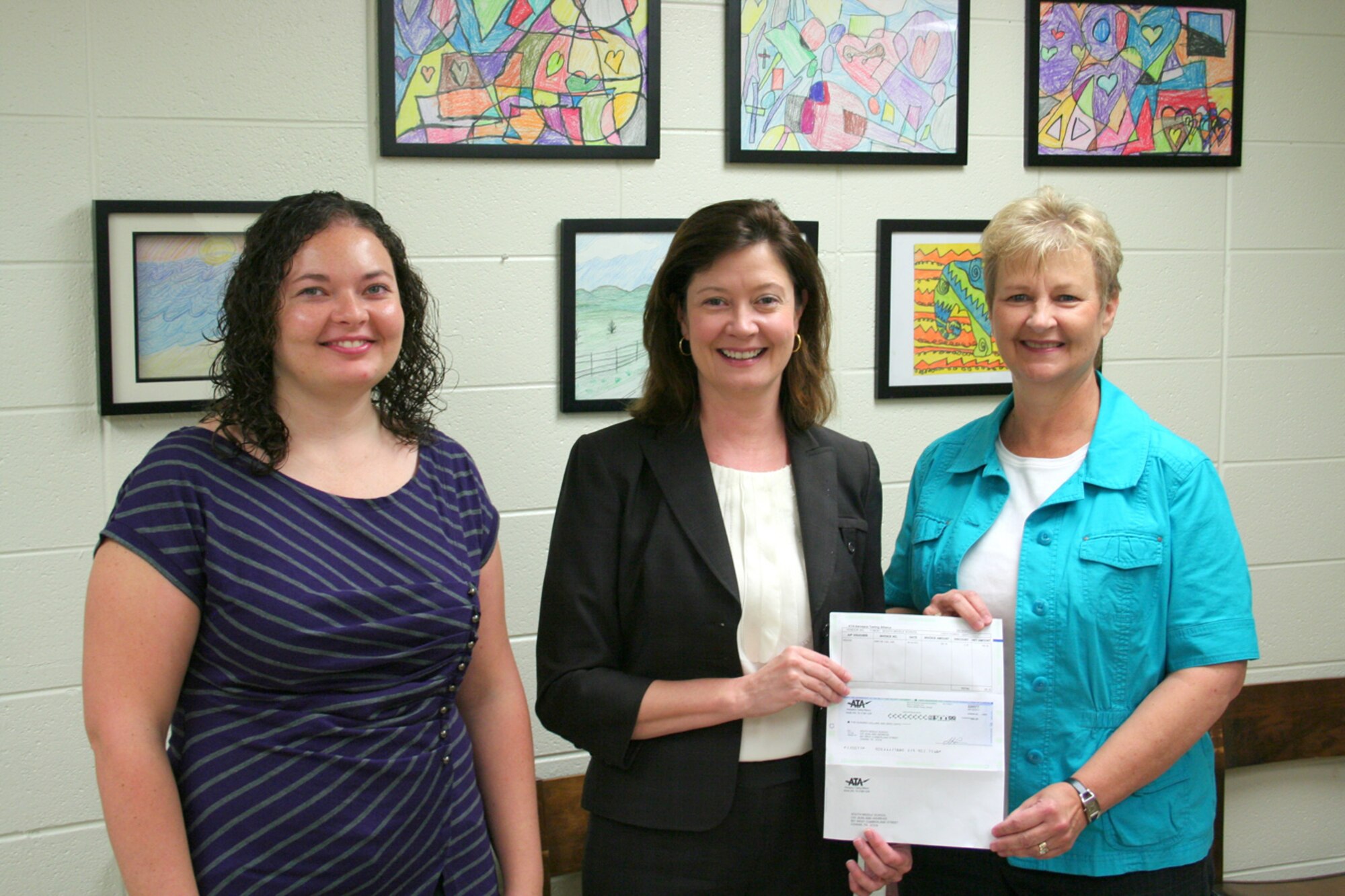 Kathy Gattis, ATA Public Affairs manager, presents a $500 donation to Sandra Stewart (right), South Middle School (SMS) principal, and Karen Mathews, teacher, to purchase a LEGO robotics kit to use in promoting STEM education at the school. The robot will be used by the SMS LEGO League team and by science classes at the school. (Photo provided)