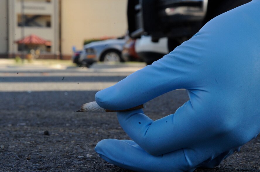 Airman 1st Class Dalton Clark, 2nd Aircraft Maintenance Squadron aircraft structural maintenance, picks up a cigarette butt in the parking lot outside of the Stratofortress dorm Nov. 2 on Barksdale Air Force Base, La. He was chosen as part of the bay-orderly program to make sure the areas in and around the dorms are kept clean. (U.S. Air Force photo/Airman 1st Class Andrea F. Liechti)(RELEASED)
