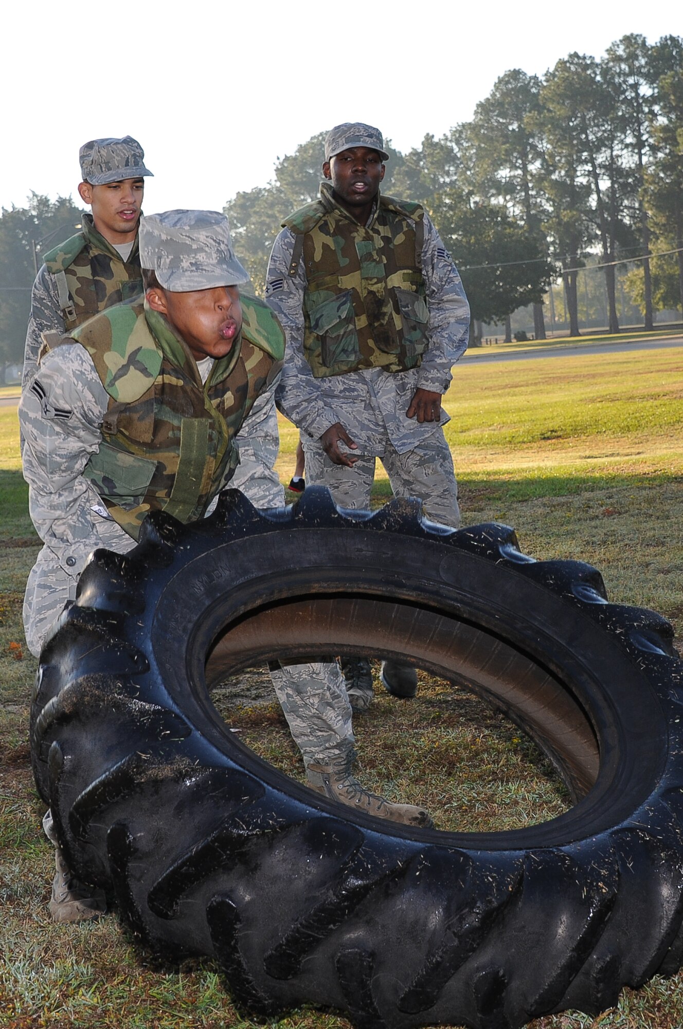 Members of the Electronic Systems Center prepare to toss a tire during their combat fitness challenge Oct. 27 on Gunter Annex. (Air Force photo/Melanie Rodgers Cox)