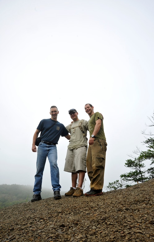 At the end of a group hike, Chaplain (Capt.) Daniel Kamzan, far right, stands proudly atop a mountain in New Castel, Va., with Chaplain (Capt.) Mark Hunsinger, left, 11 WG chaplain, and Staff Sgt. Frank Rivas, middle, 11 WG assistant on Sep. 22. Together, the men participated as mentors in a week-long, JBA Chapel sponsored wilderness retreat which culminated with a two-mile group hike on the last day of the retreat. (U.S. Air Force photo/Airman 1st Class Lindsey A. Beadle)